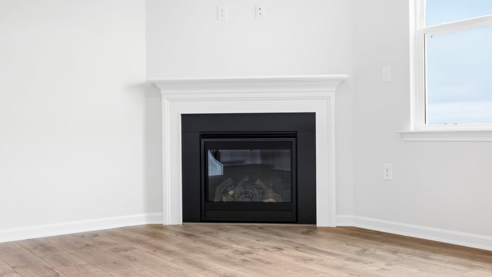 Living area with fireplace and windows.