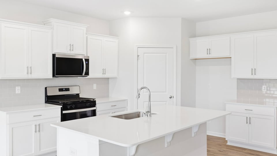 Kitchen with island and cabinets.