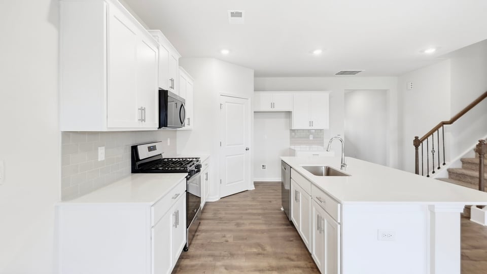 Kitchen with island and cabinets.