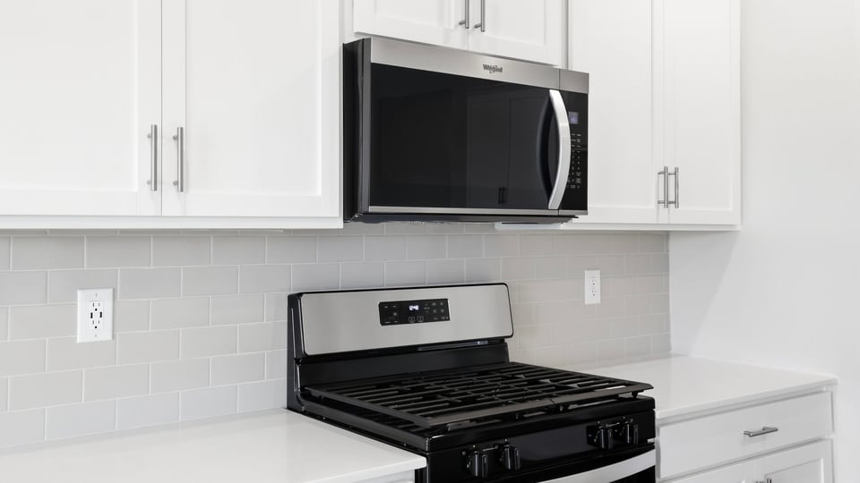 Kitchen with island and cabinets.
