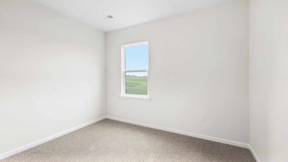 Bedroom with carpet and windows.