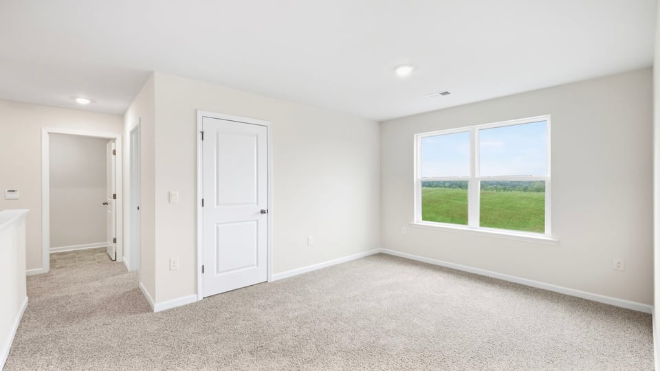 Loft with carpet and windows.