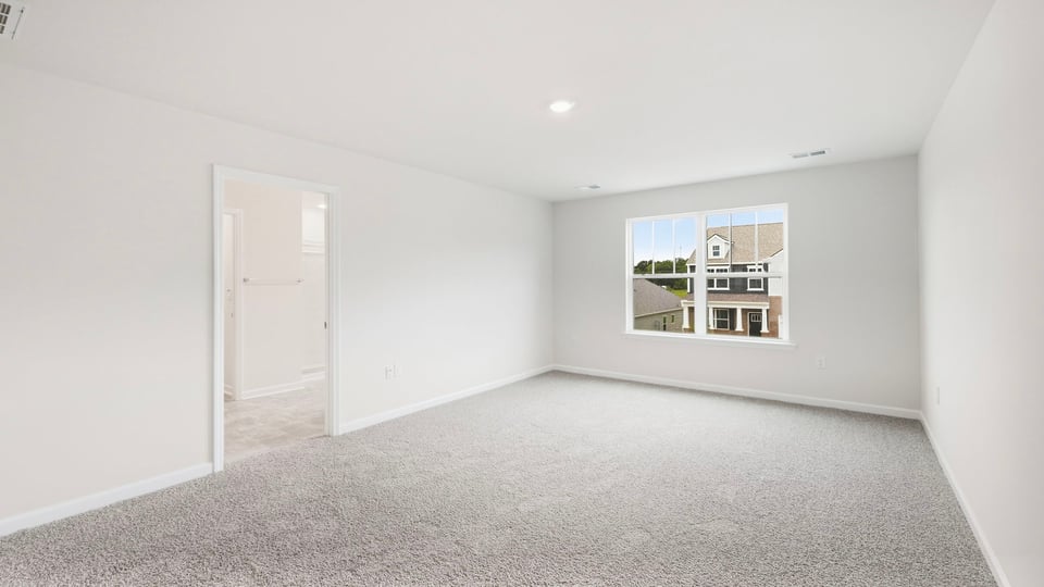 Bedroom with carpet and windows.