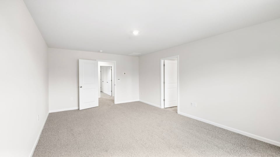 Bedroom with carpet and windows.
