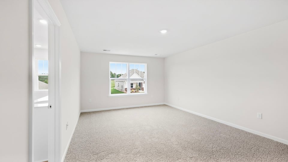 Bedroom with carpet and windows.