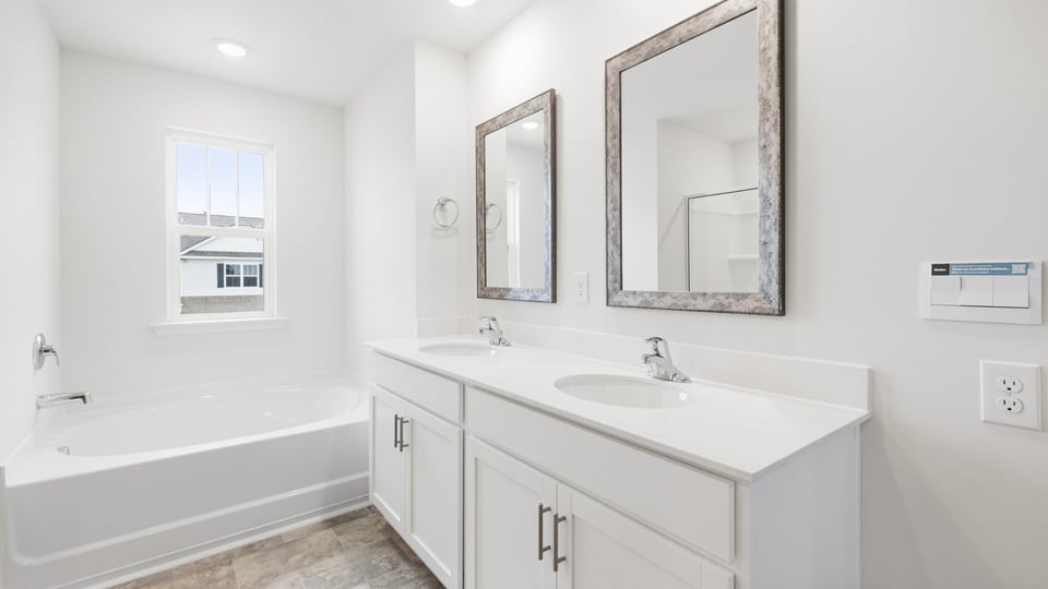 Primary bathroom with double vanity sinks.