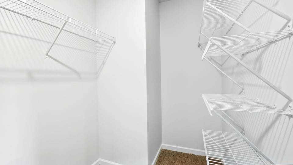 Primary closet with shelf.