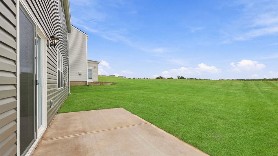 Back exterior with large backyard.