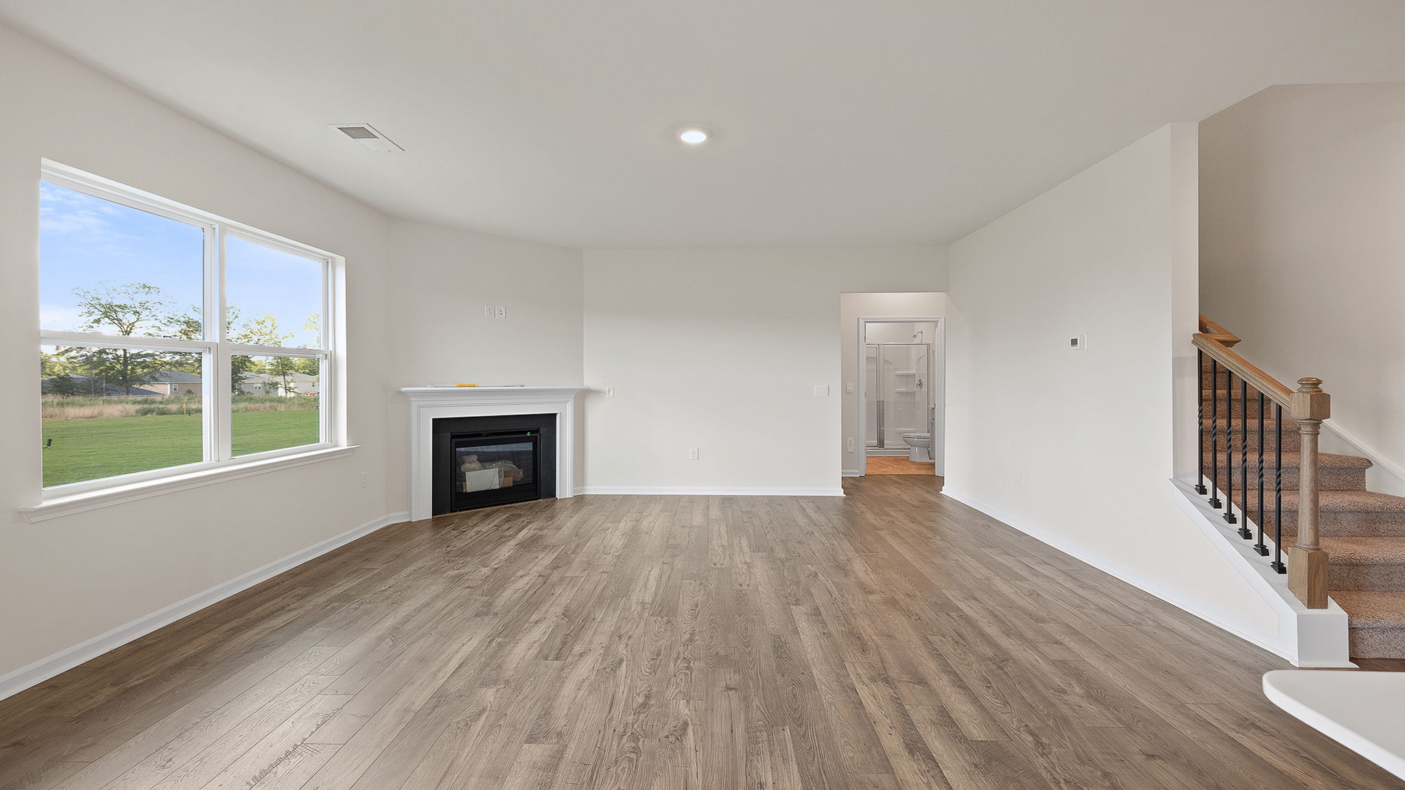Family room with fireplace and windows.