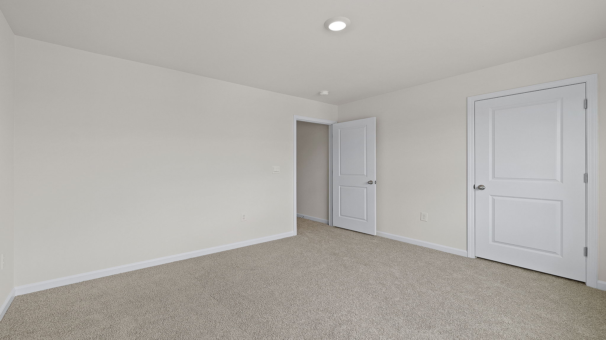 Bedroom with carpet and windows.
