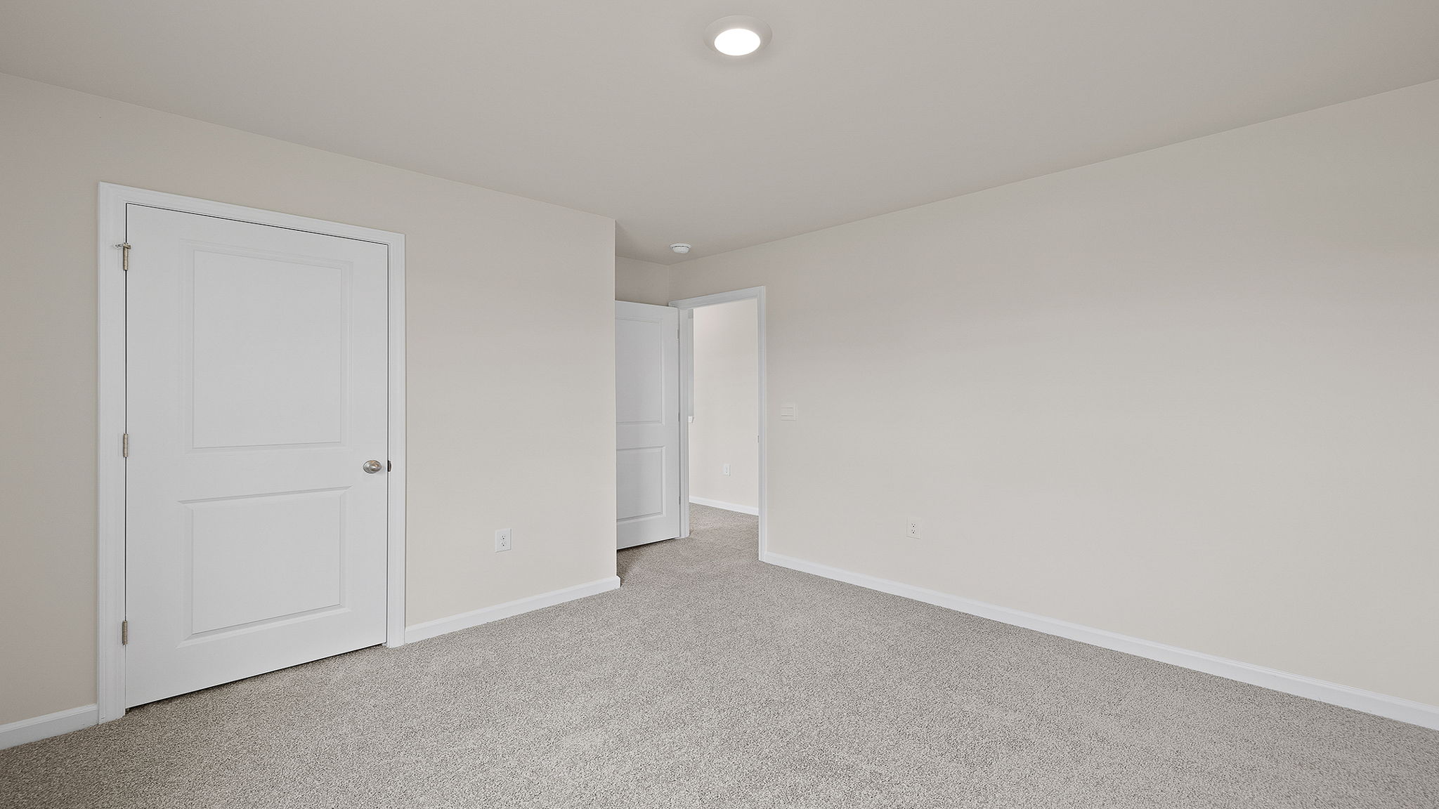 Bedroom with carpet and windows.
