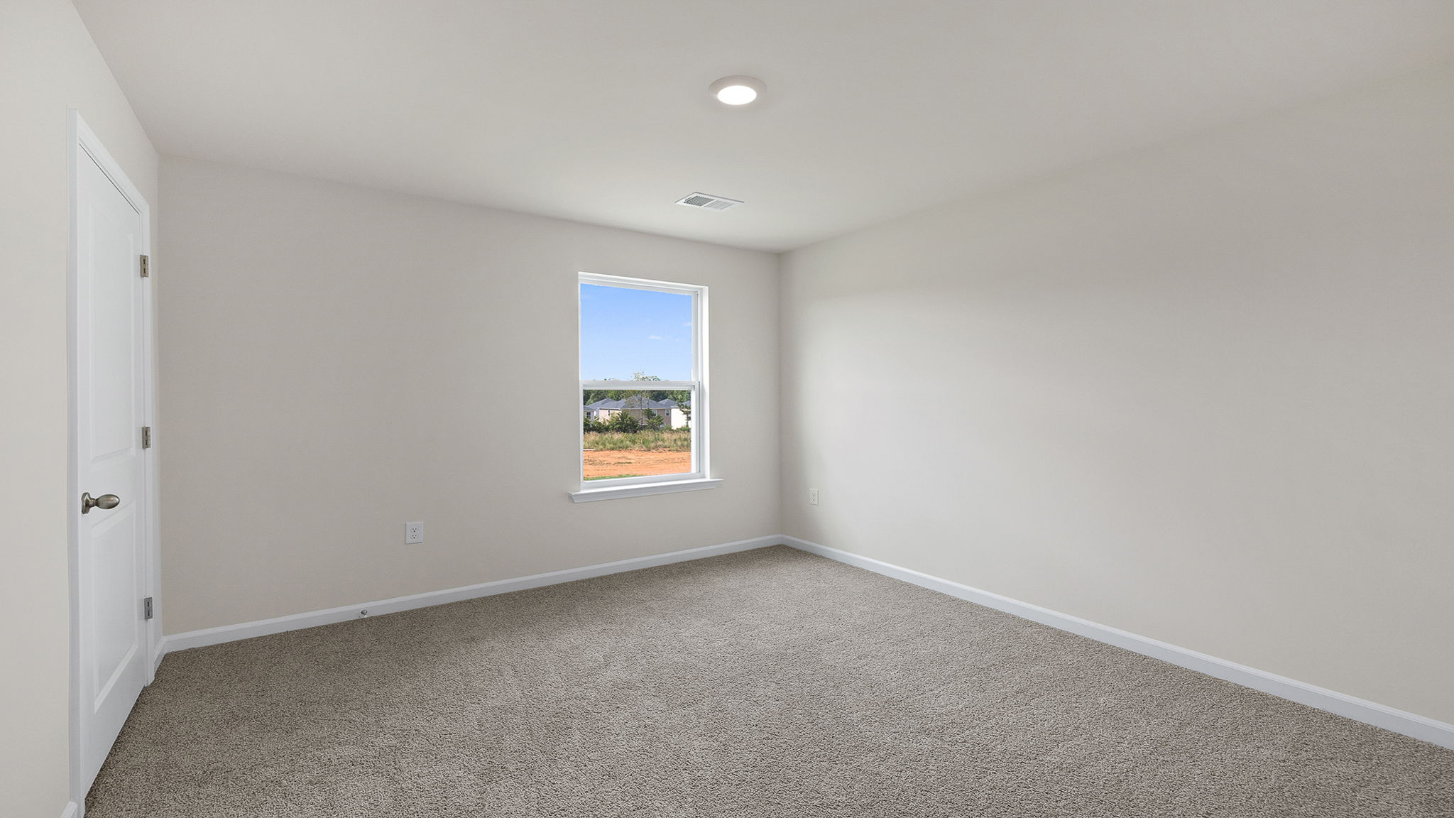Bedroom with carpet and windows.