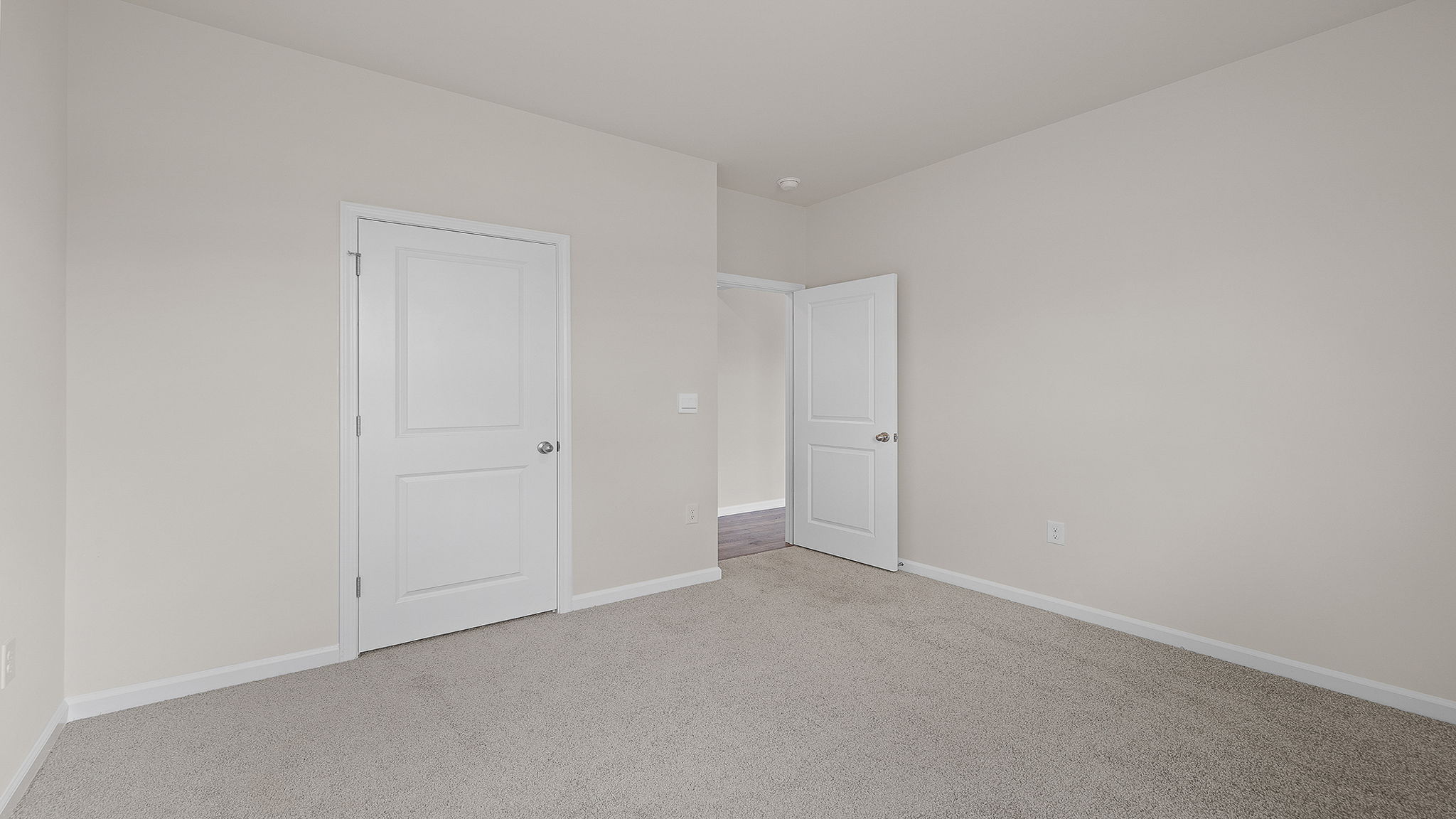 Bedroom with carpet and windows.