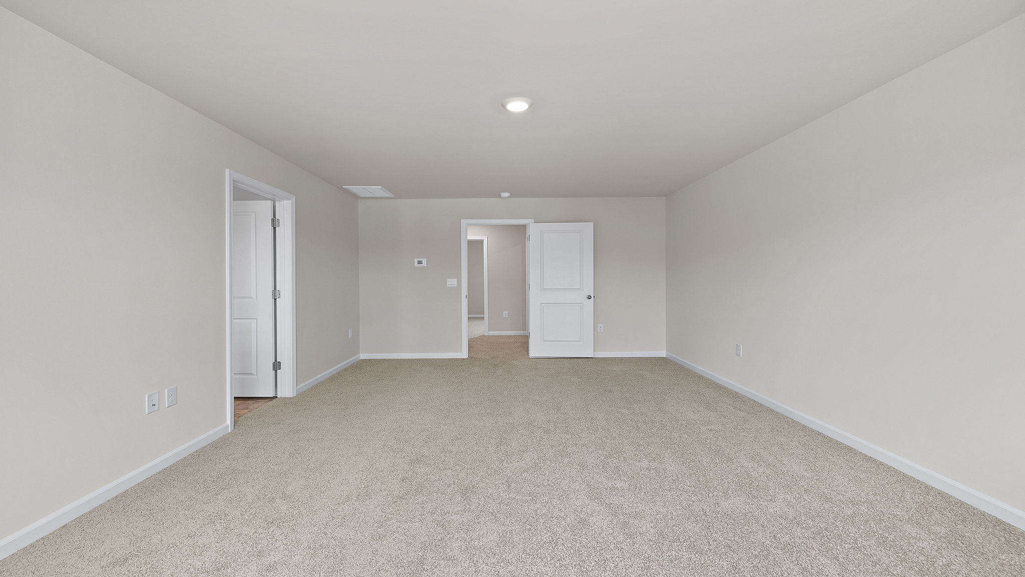 Bedroom with carpet and windows.