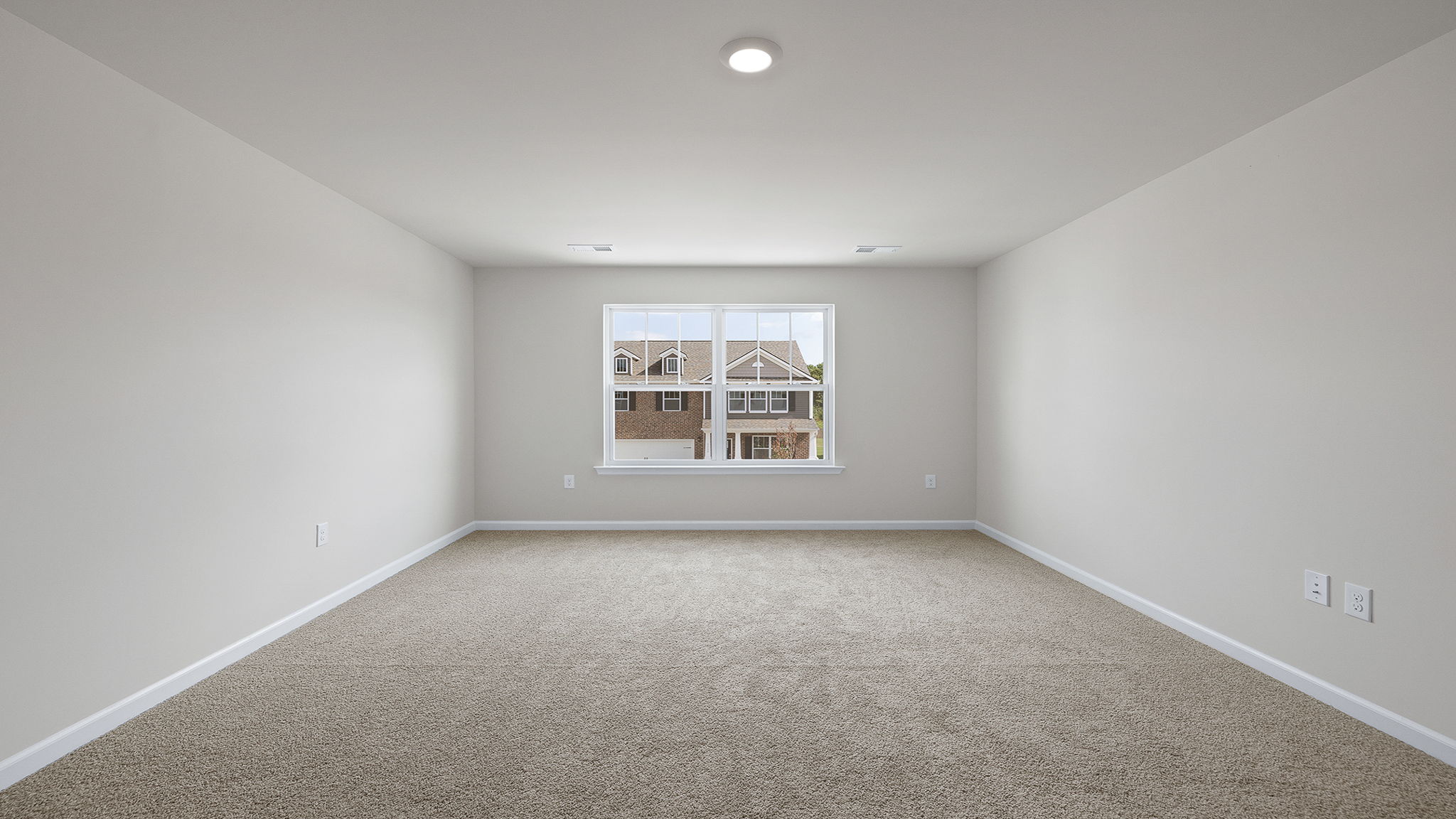 Bedroom with carpet and windows.