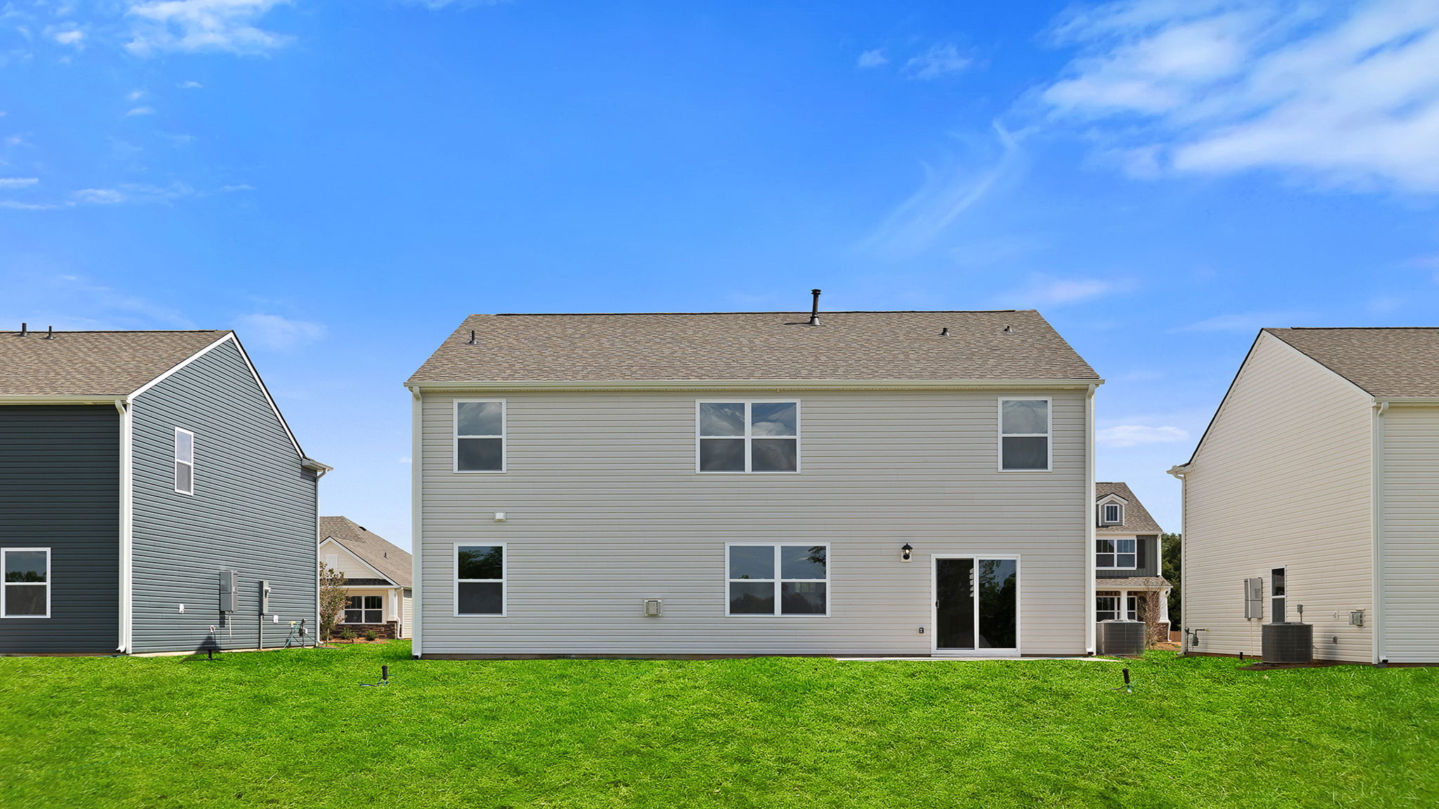Back exterior of home with large backyard.