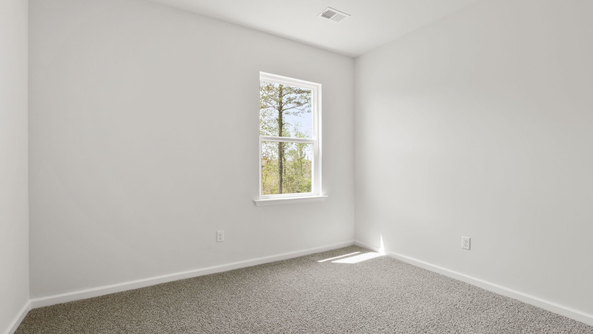 Bedroom with carpet and window.