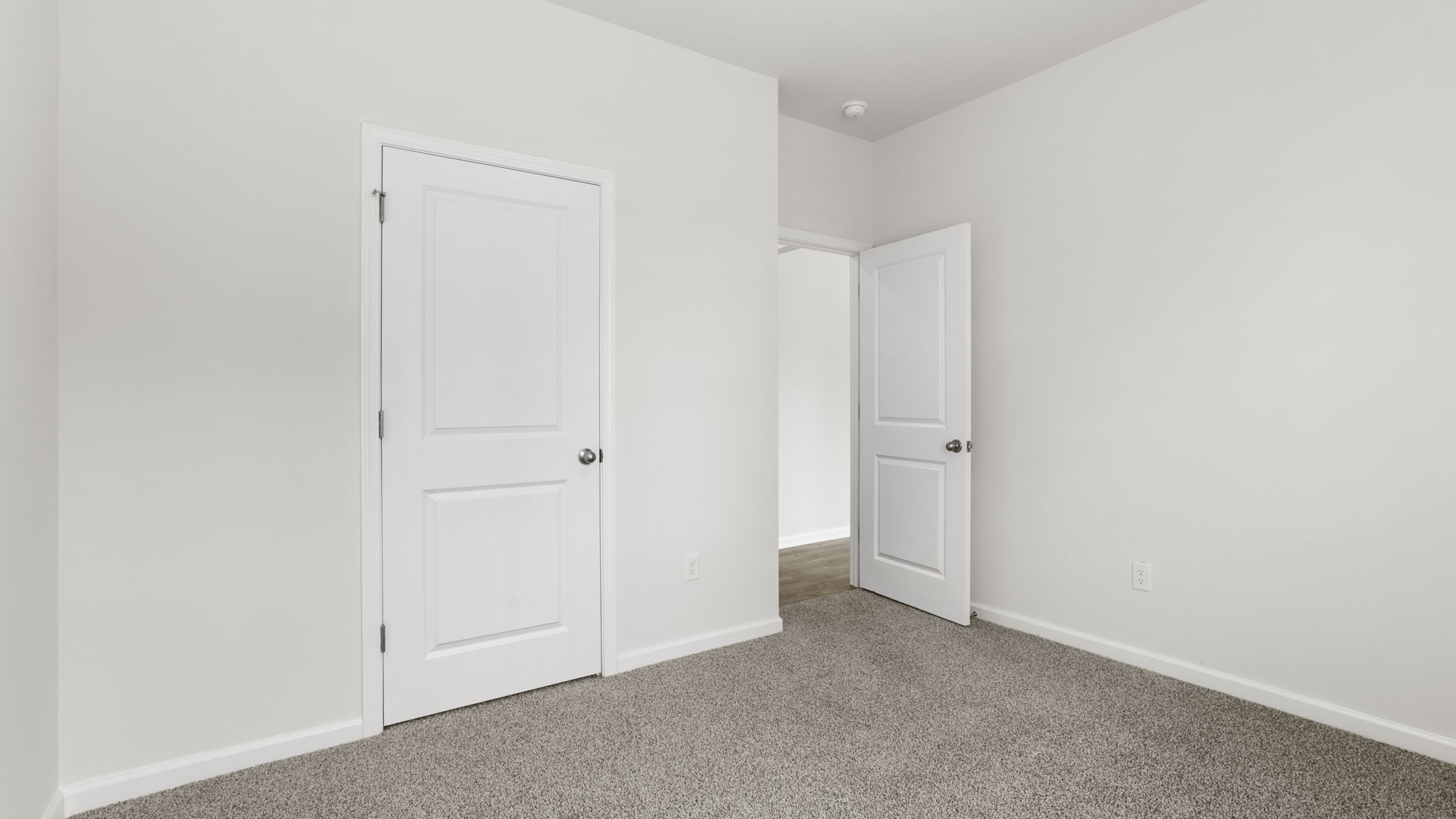 Bedroom with carpet and window.