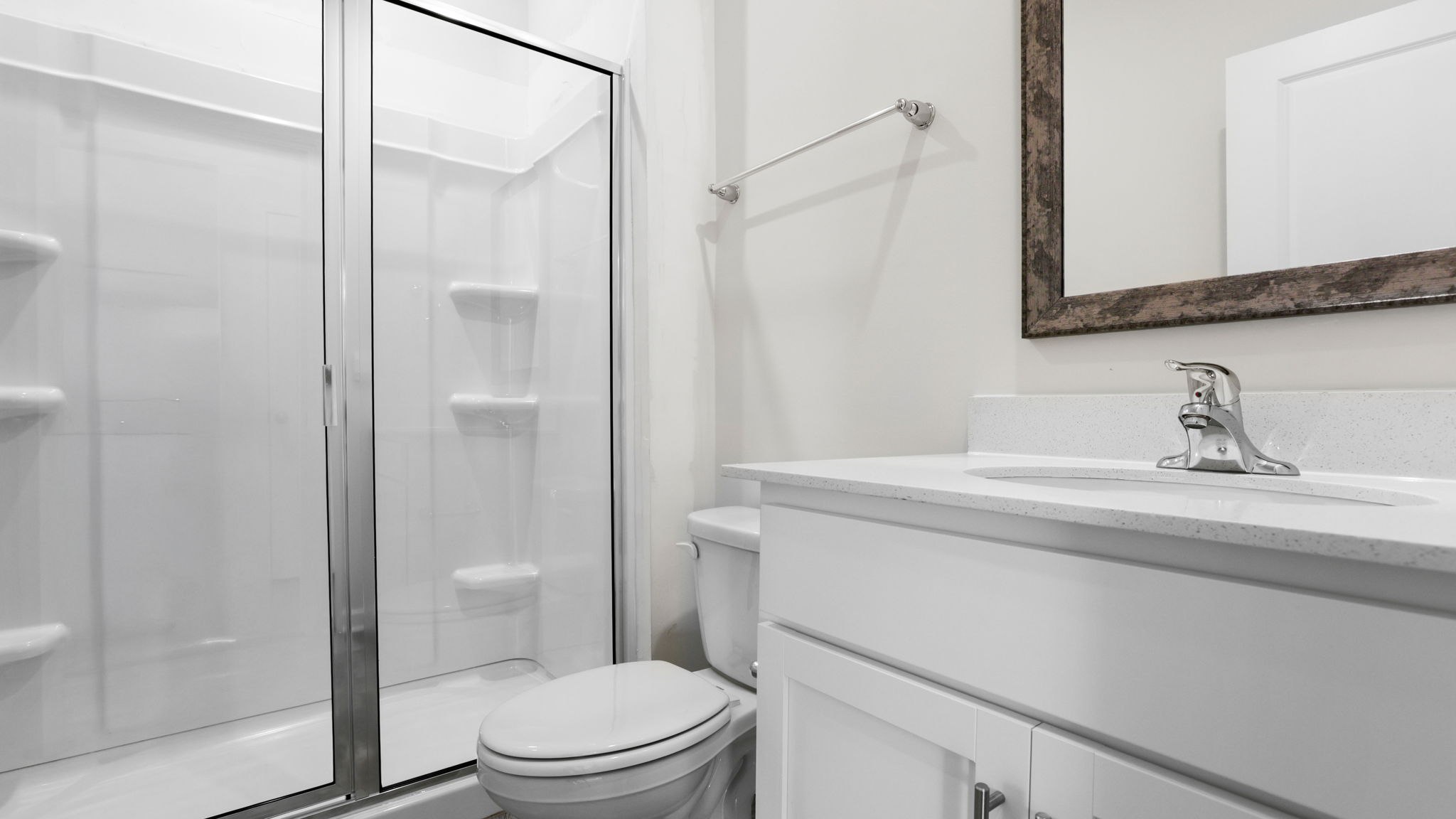 Bathroom with walk in shower and single vanity sink.