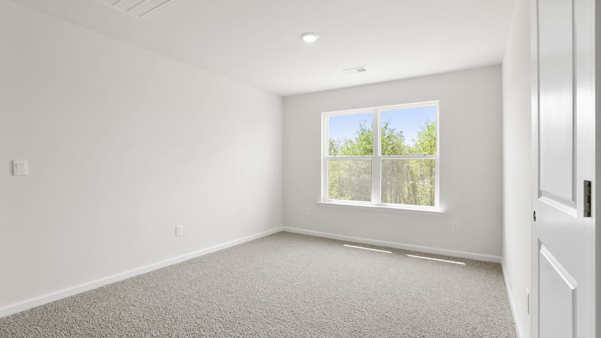 Bedroom with carpet and window.