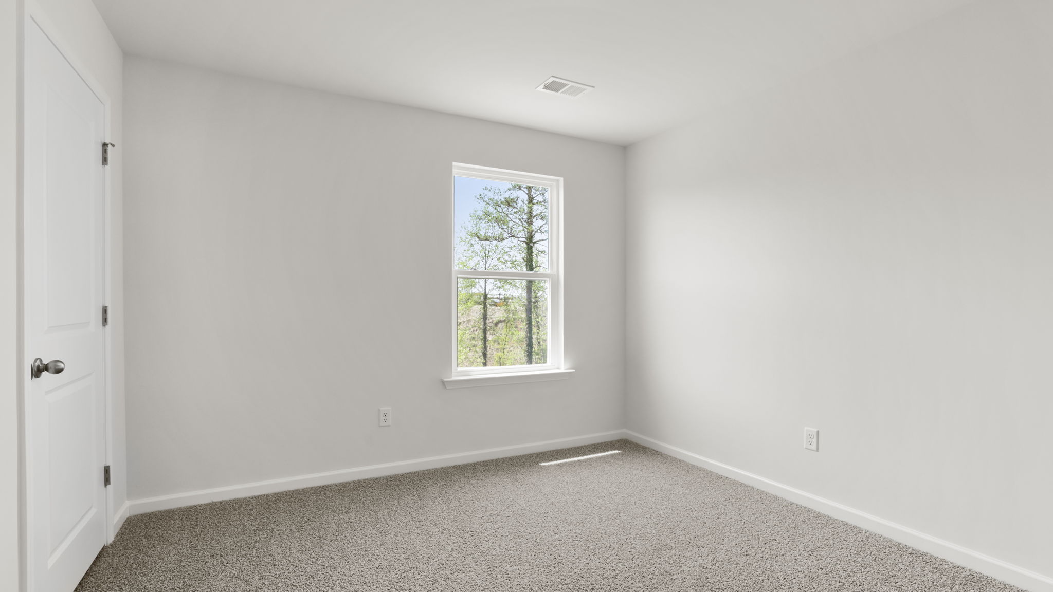 Bedroom with carpet and window.