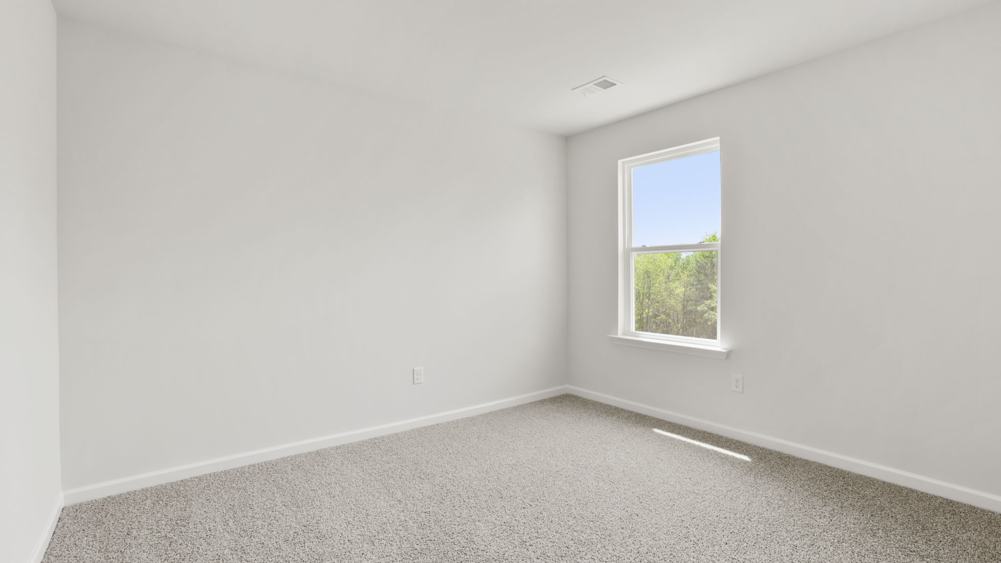 Bedroom with carpet and window.
