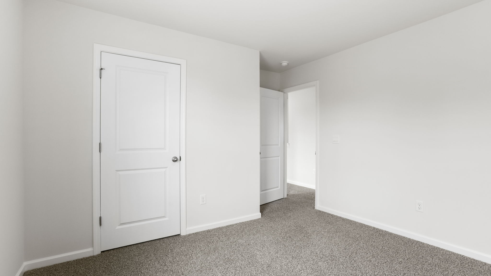 Bedroom with carpet and window.