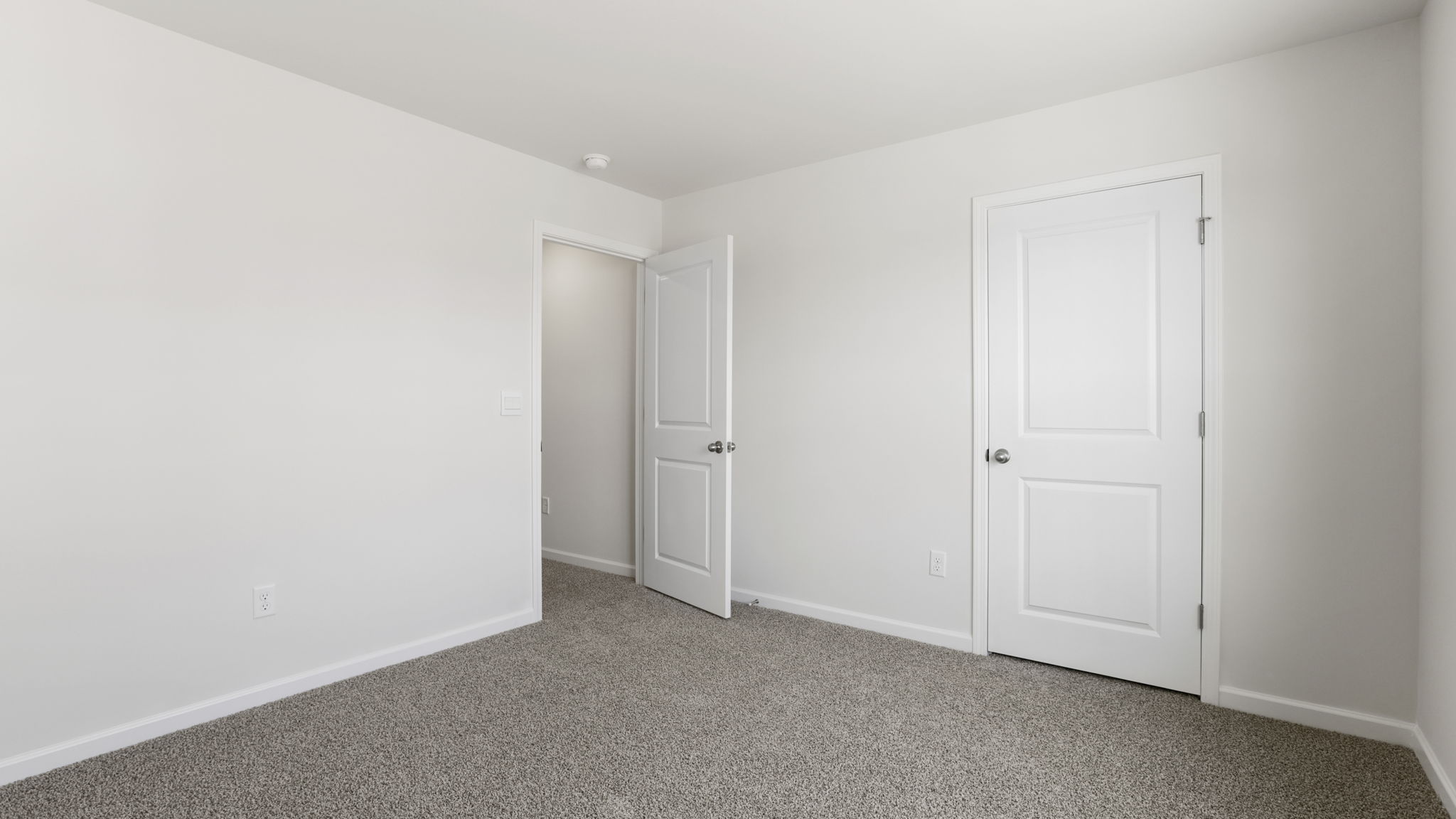 Bedroom with carpet and window.