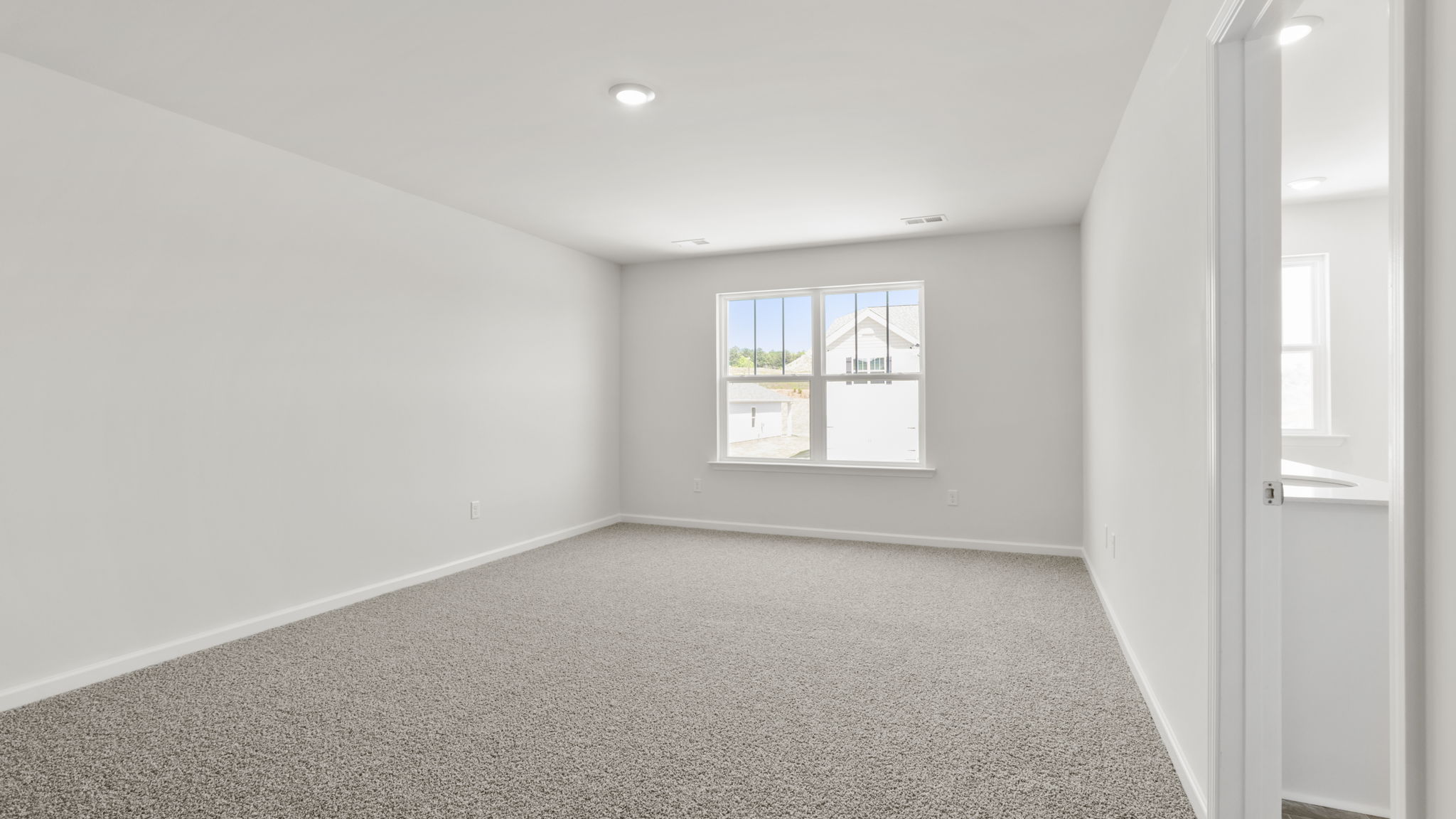 Bedroom with carpet and window.