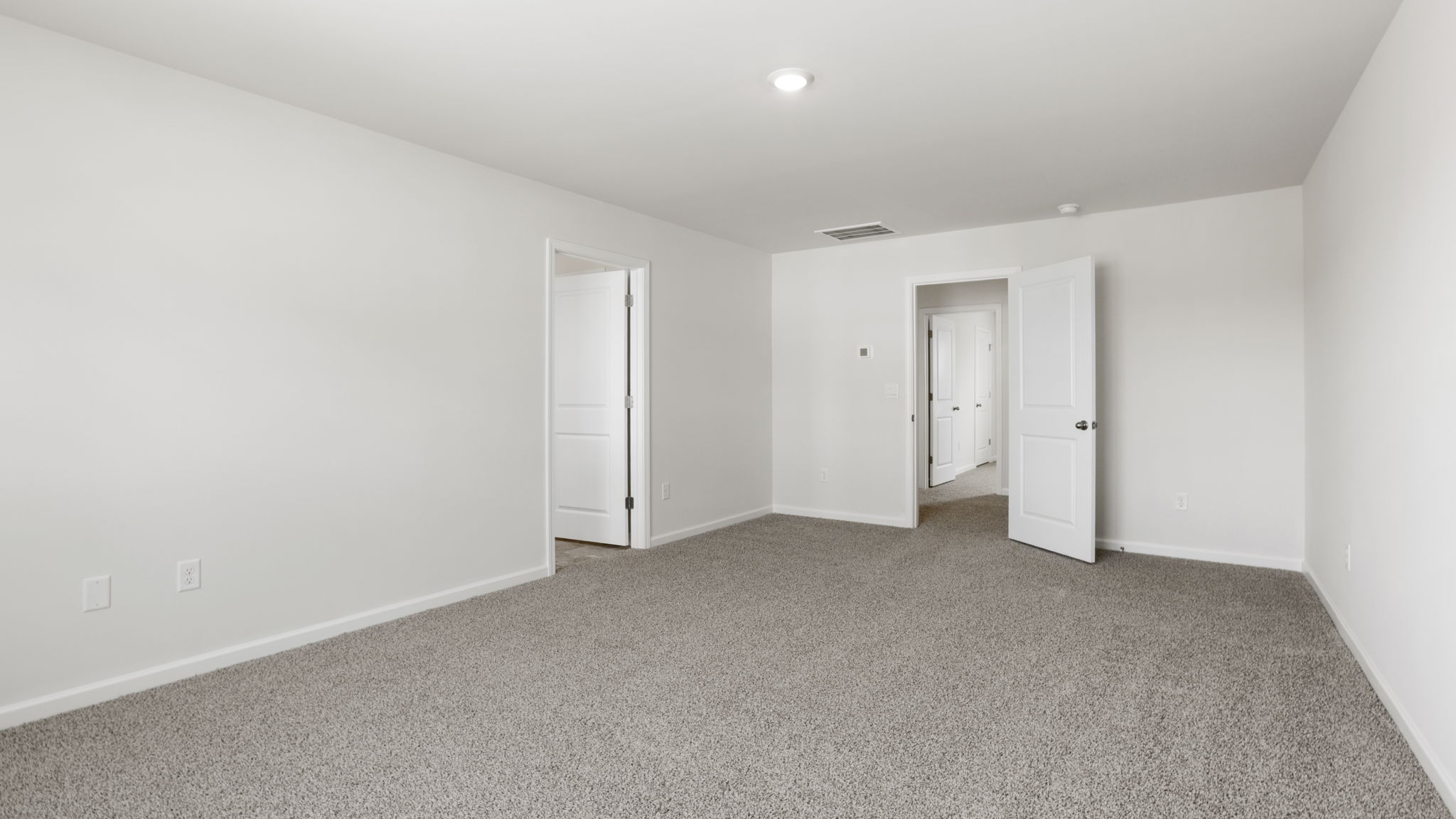 Bedroom with carpet and window.