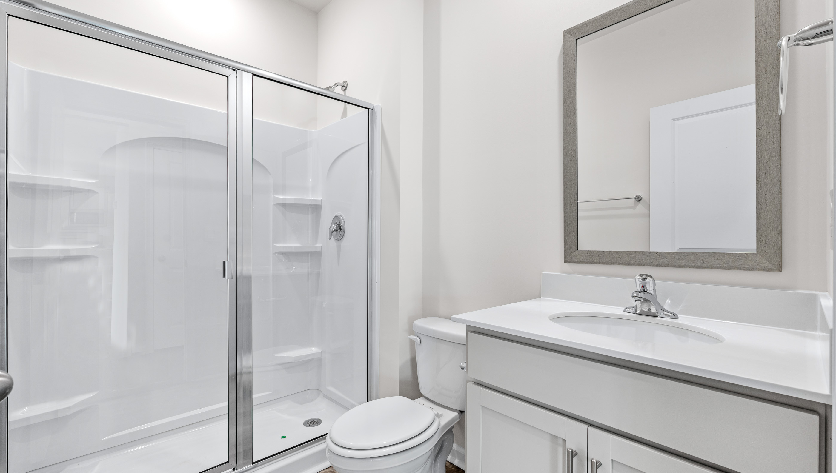 Full bath on the main level with vanity and walk-in shower.