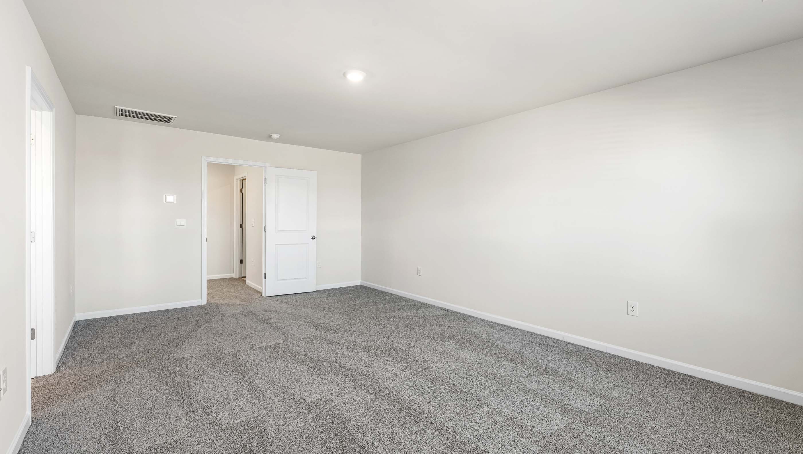 Bedroom with carpet and window.