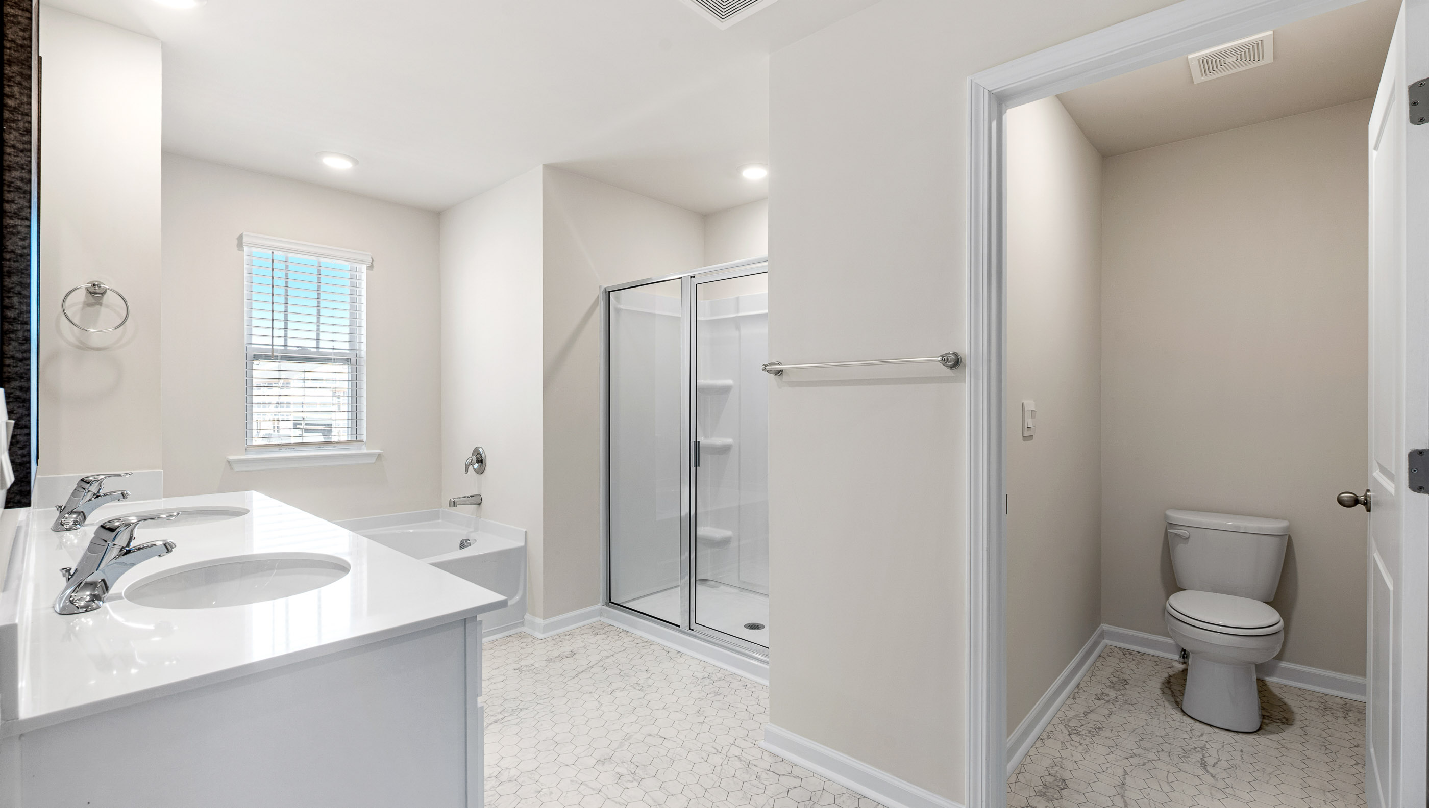 Bathroom with walk in shower and closet.
