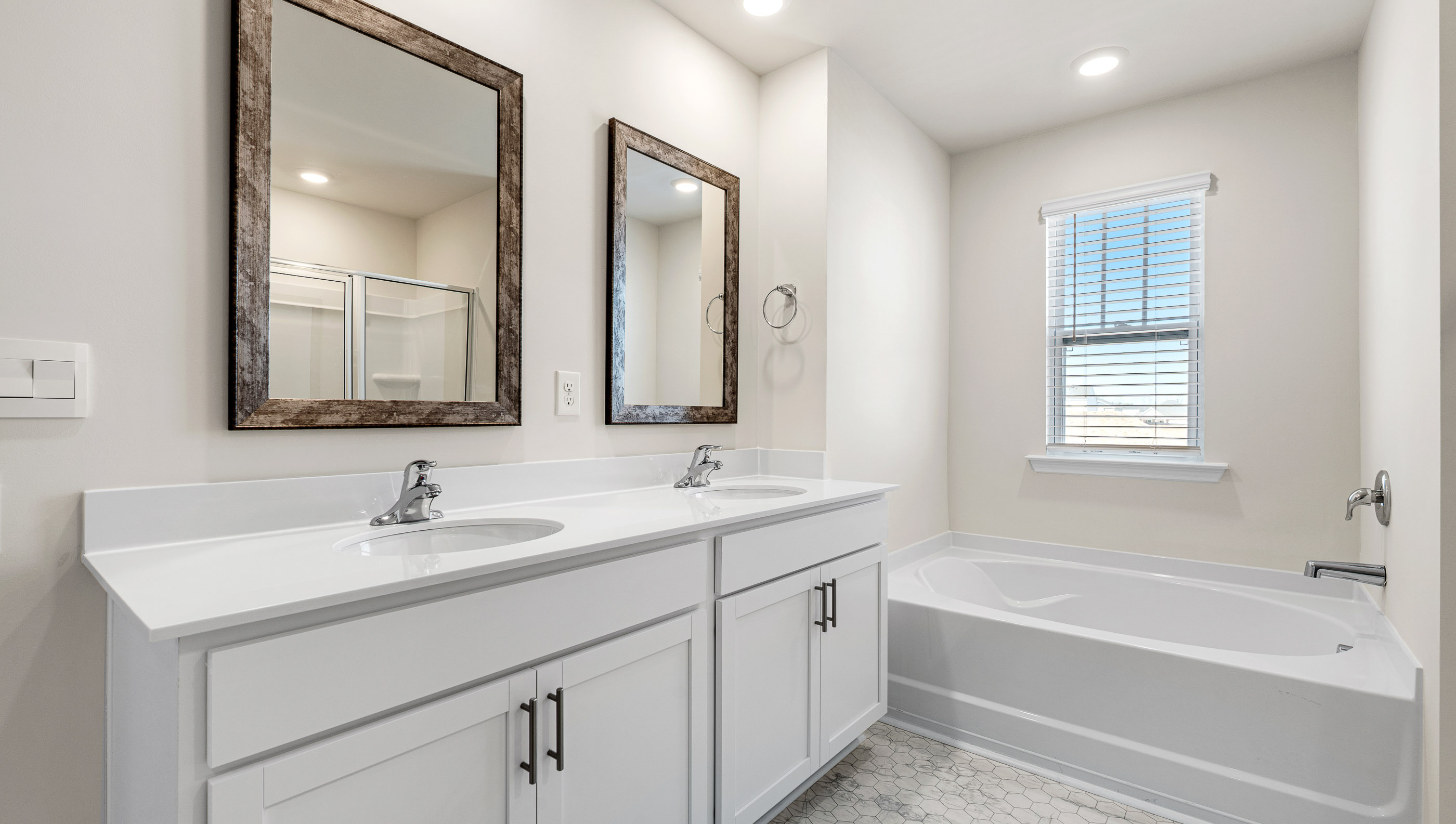 Bathroom with double vanity sink and bathtub.