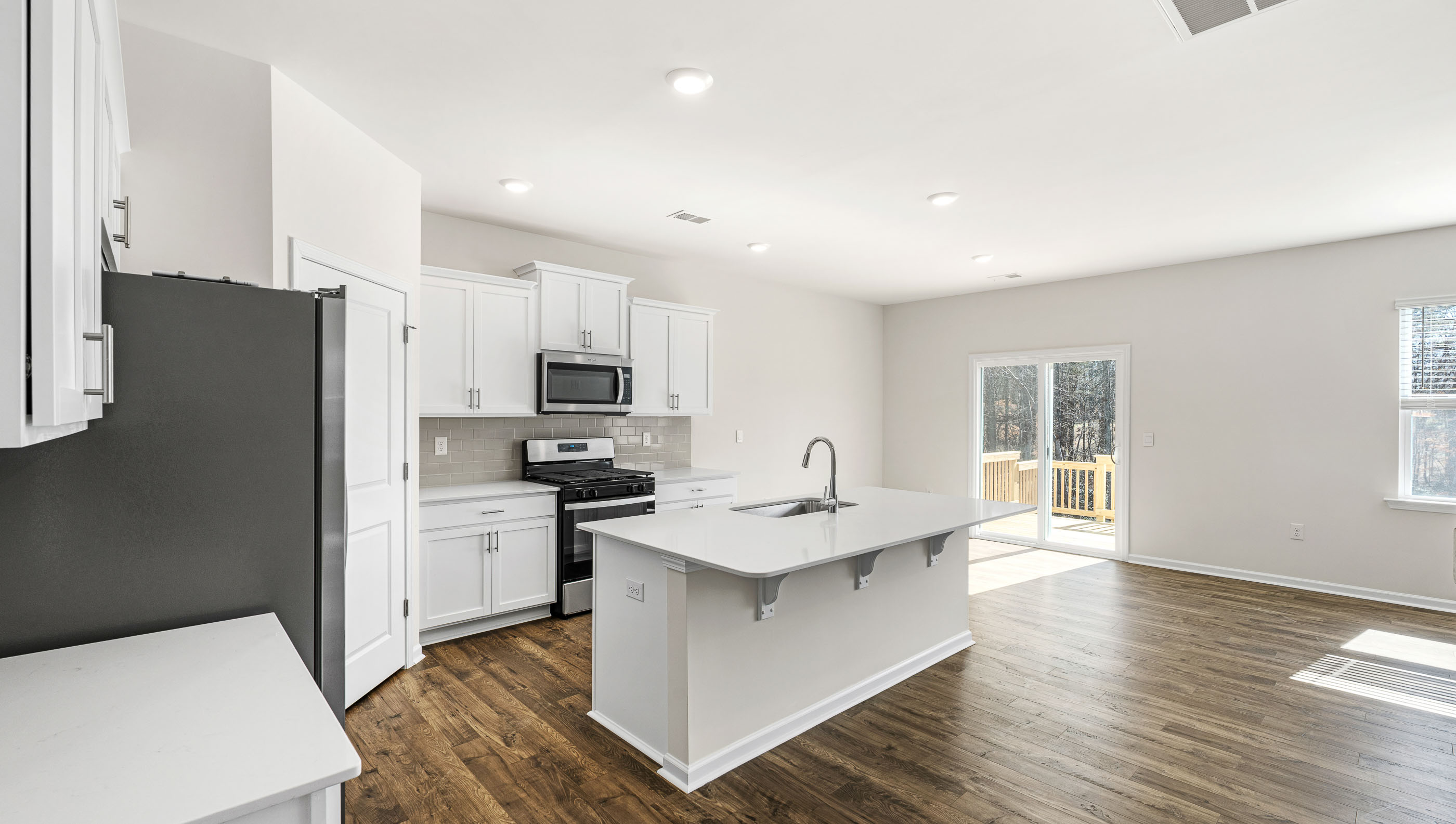 Kitchen with island and stainless steel appliances.