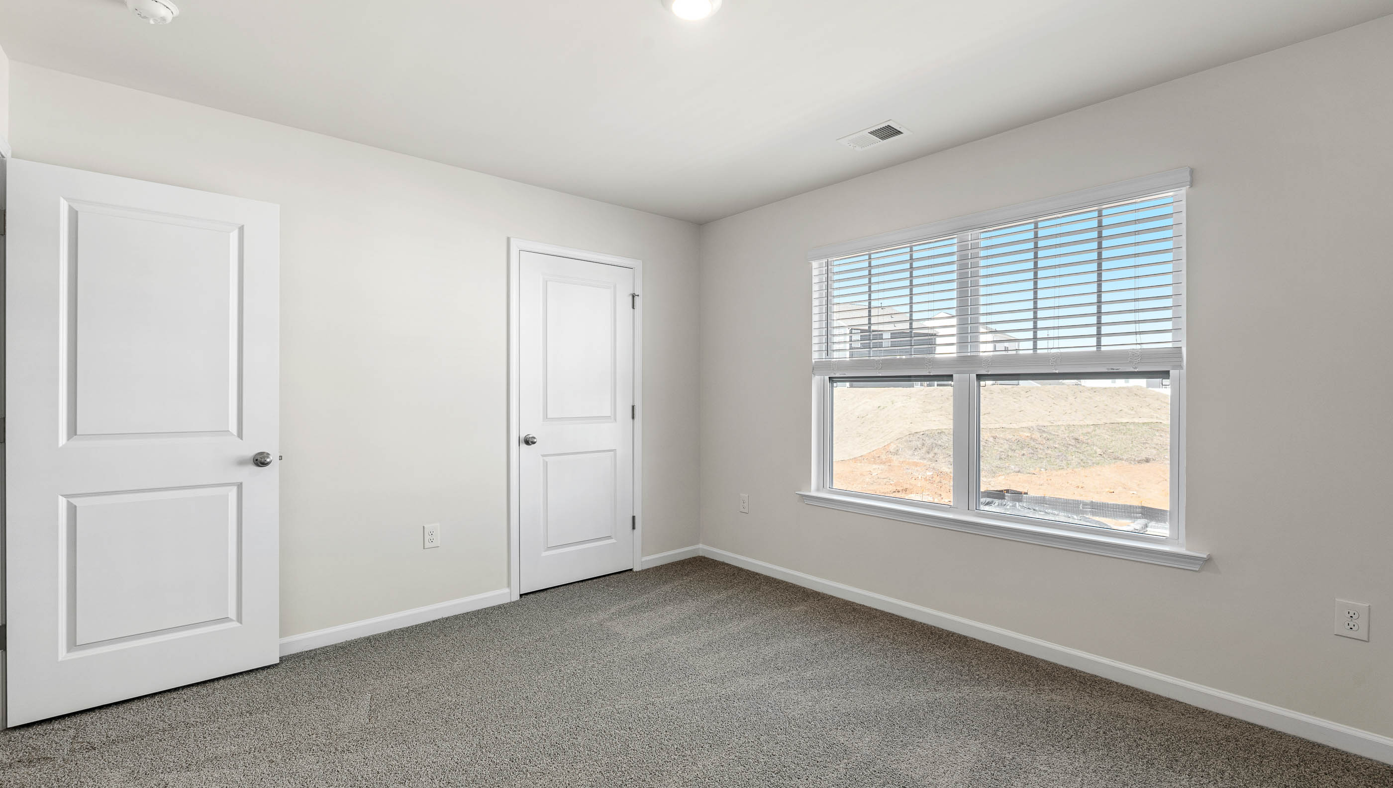 Bedroom with carpet and window.