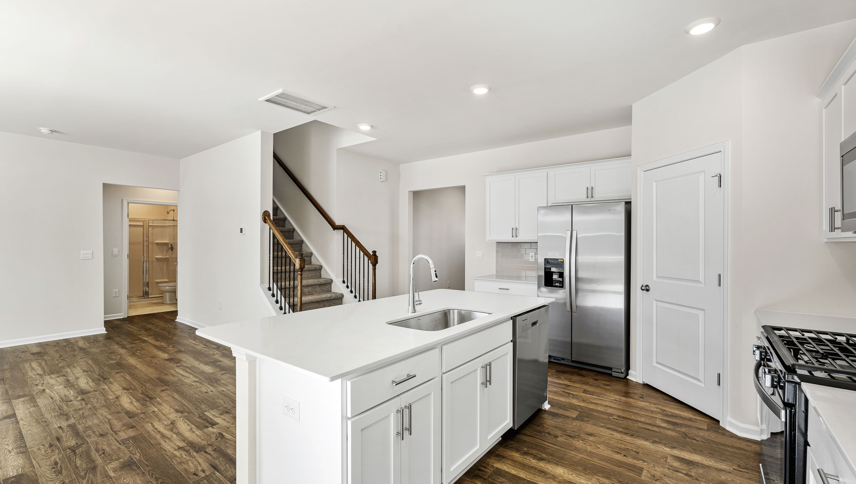 Kitchen with island and stainless steel appliances.