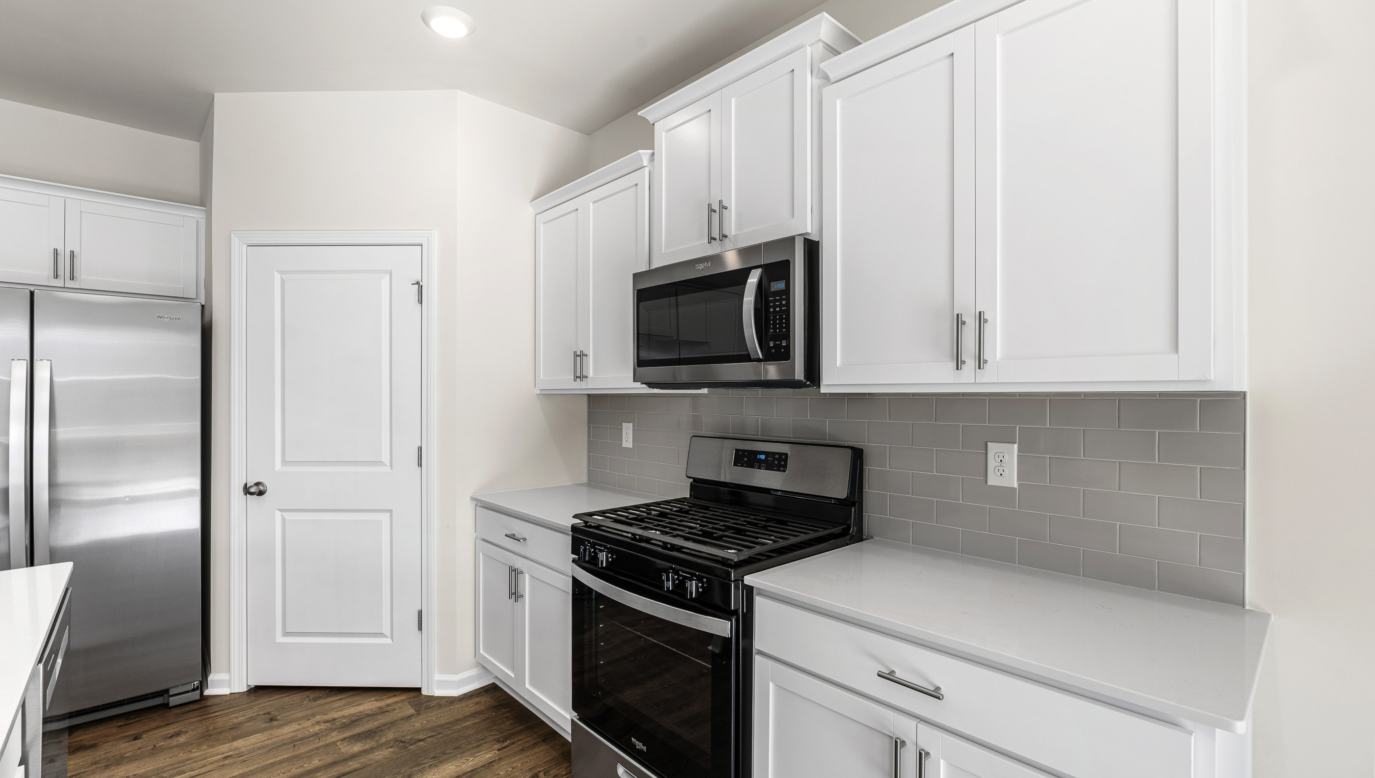 Kitchen with island and stainless steel appliances.