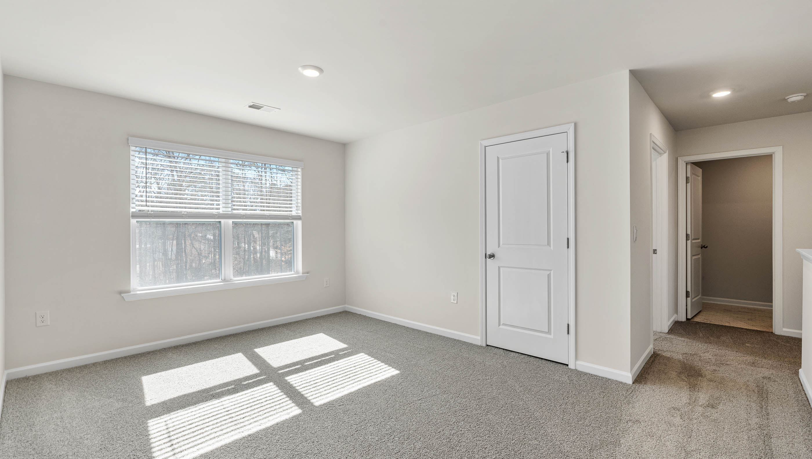 Bedroom with carpet and window.