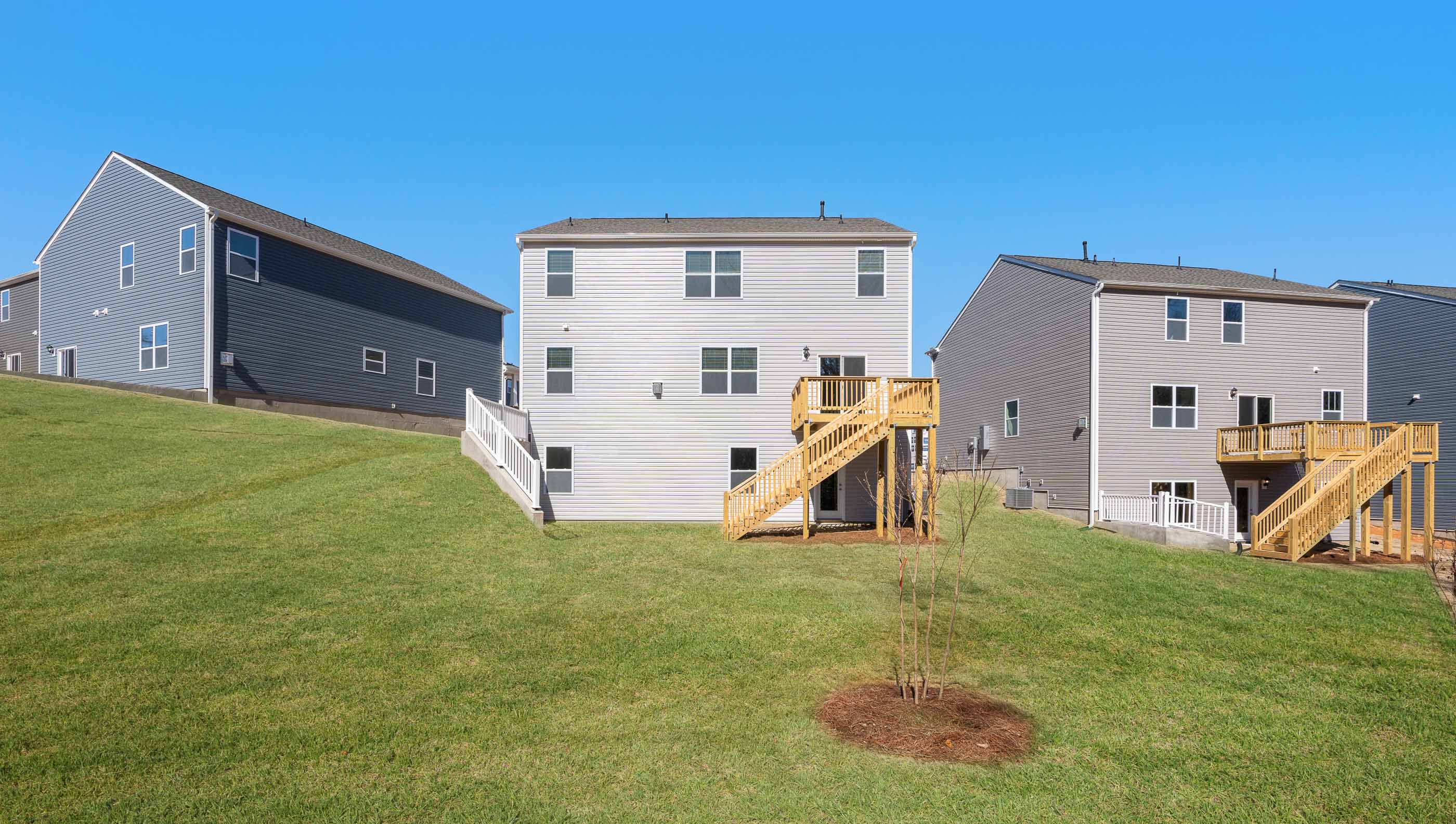 Back exterior of home with large backyard.