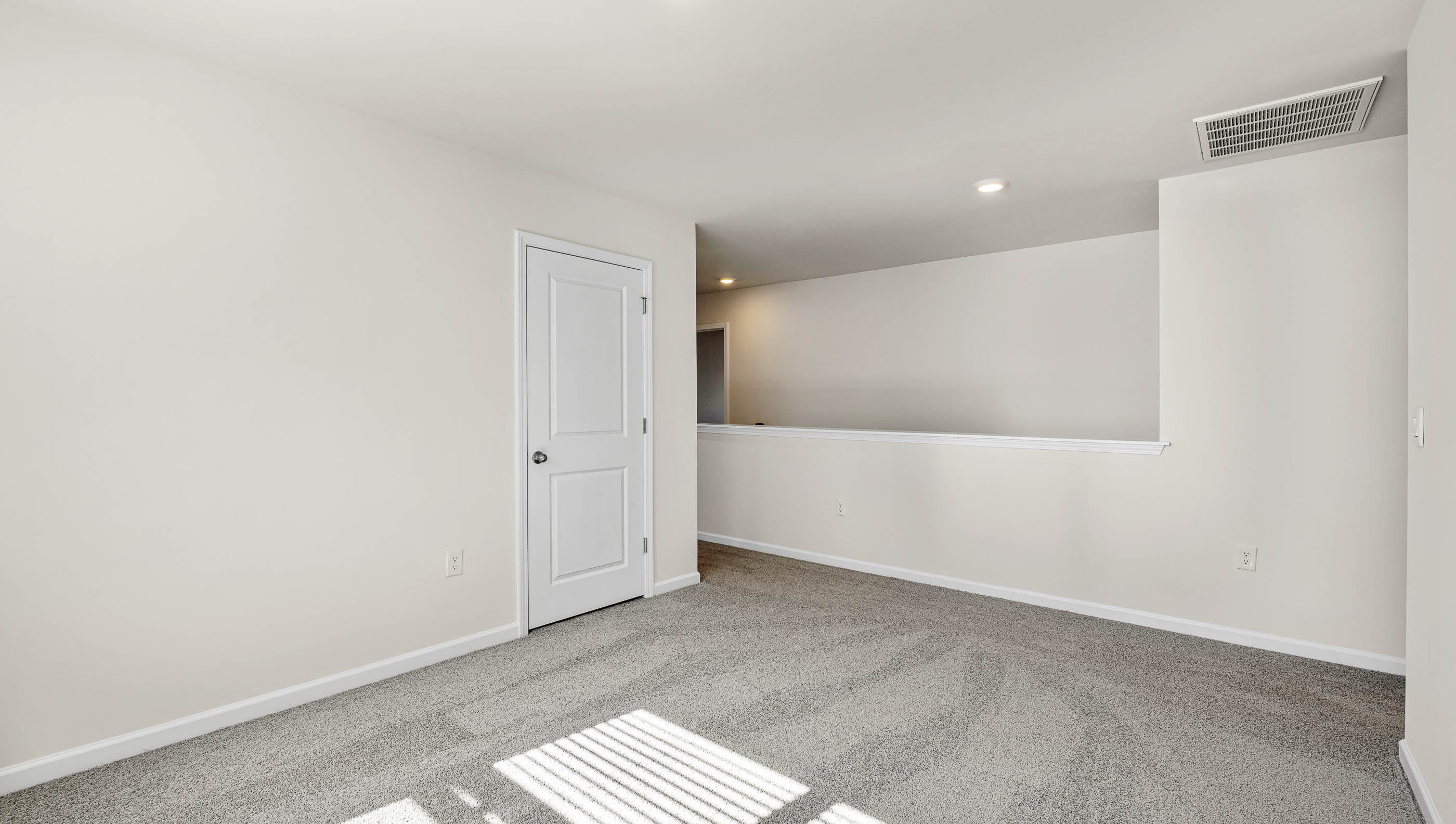Loft area with carpet.