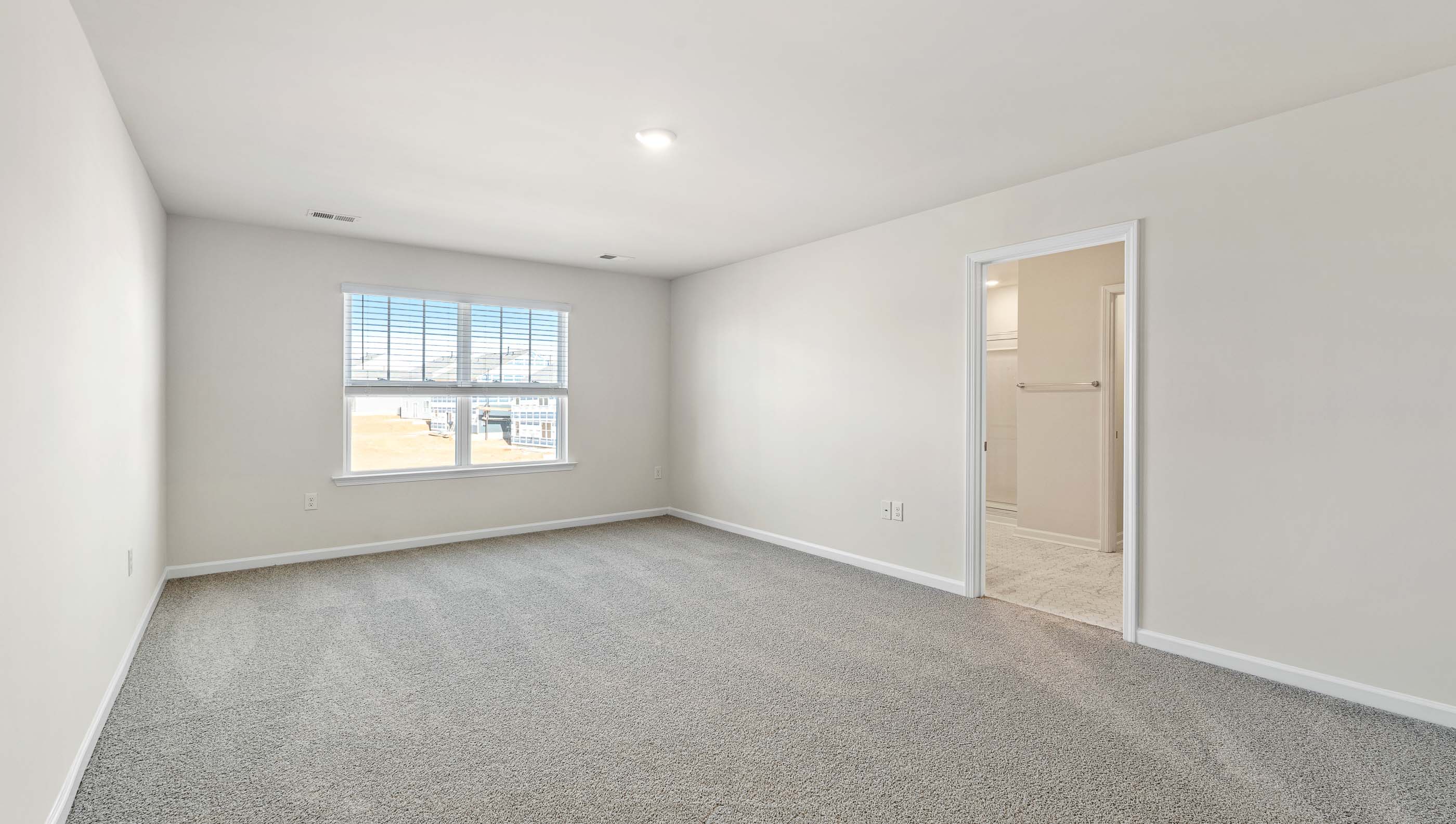 Bedroom with carpet and window.
