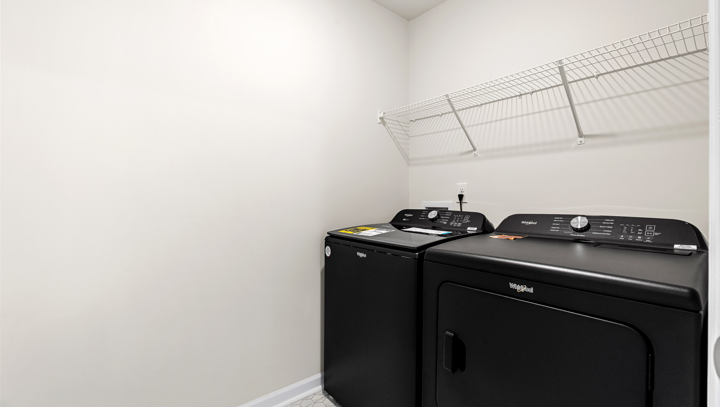 Laundry room with hanging storage racks.