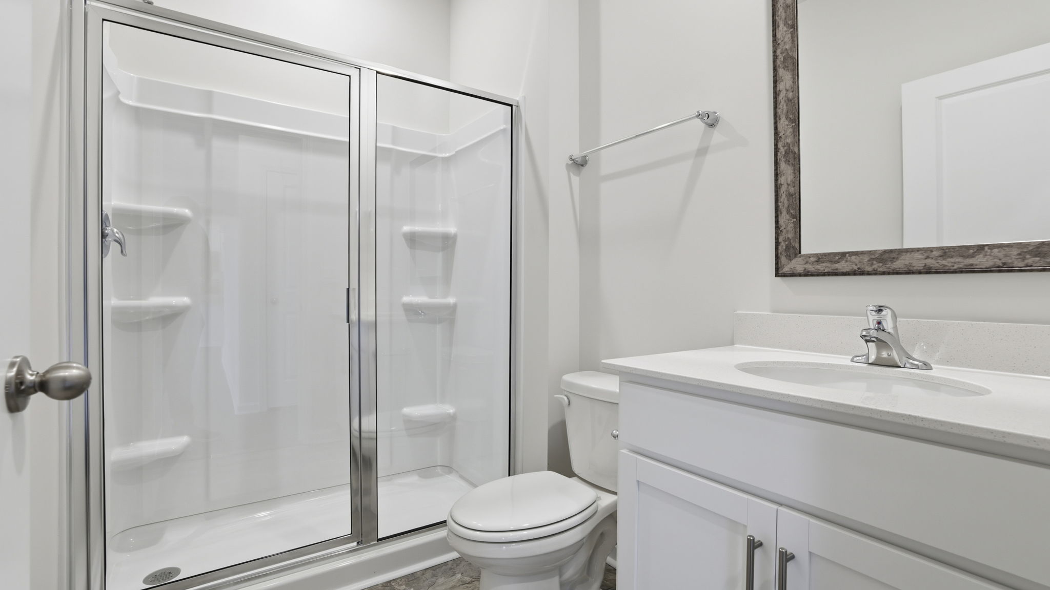 Full bathroom on the main level with vanity and walk-in shower.