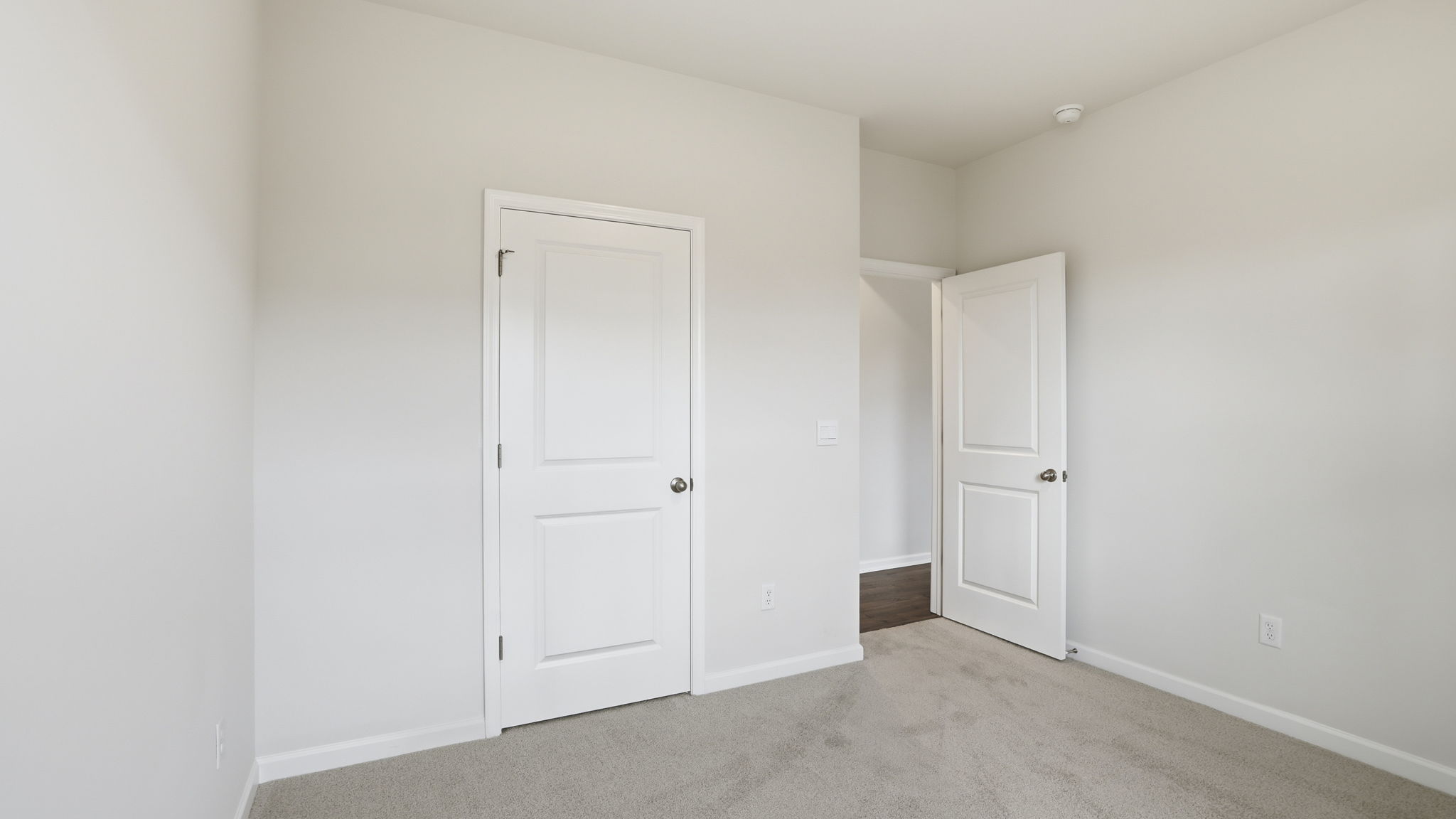 Bedroom with window and carpet.