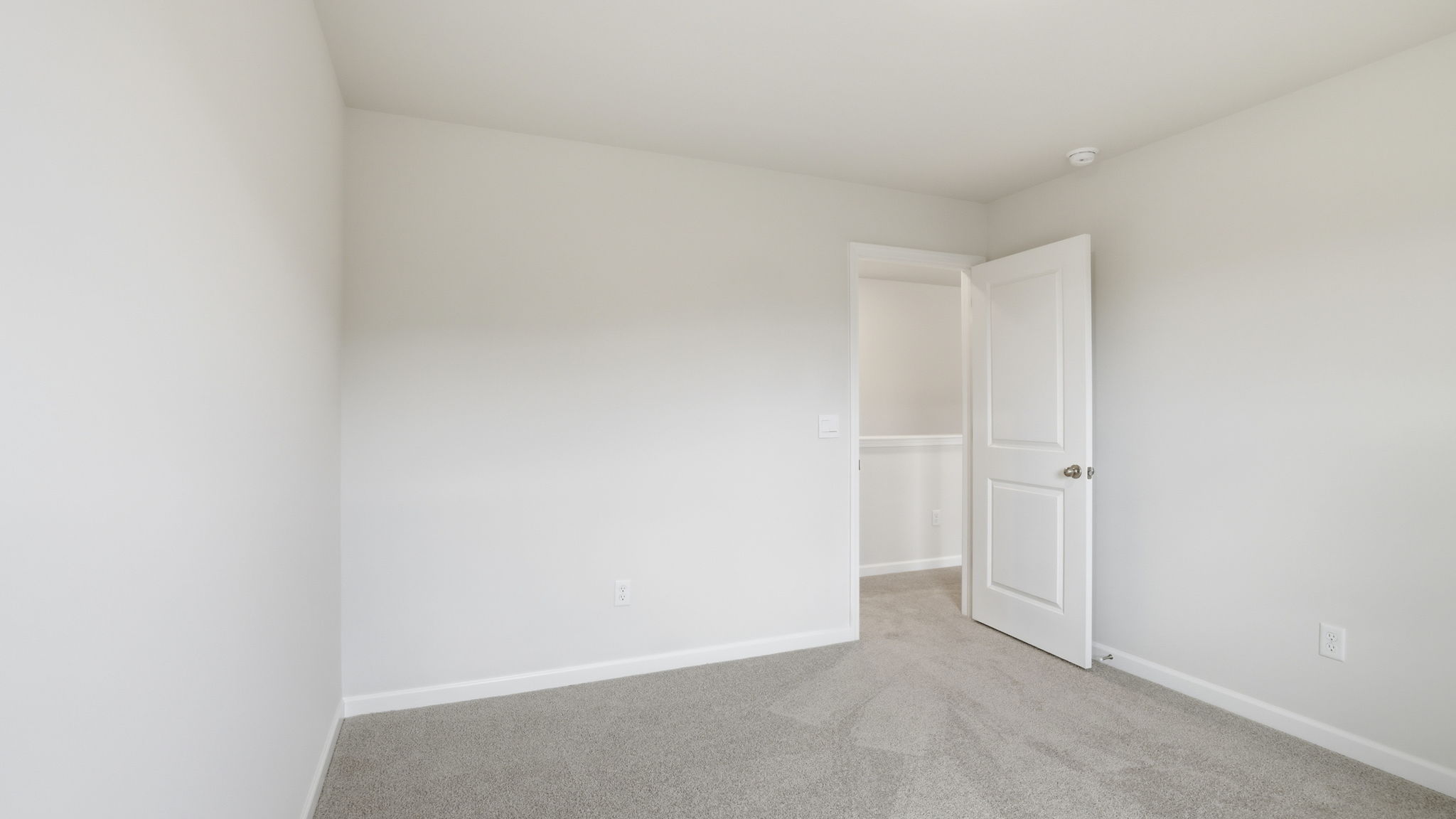 Bedroom with window and carpet.