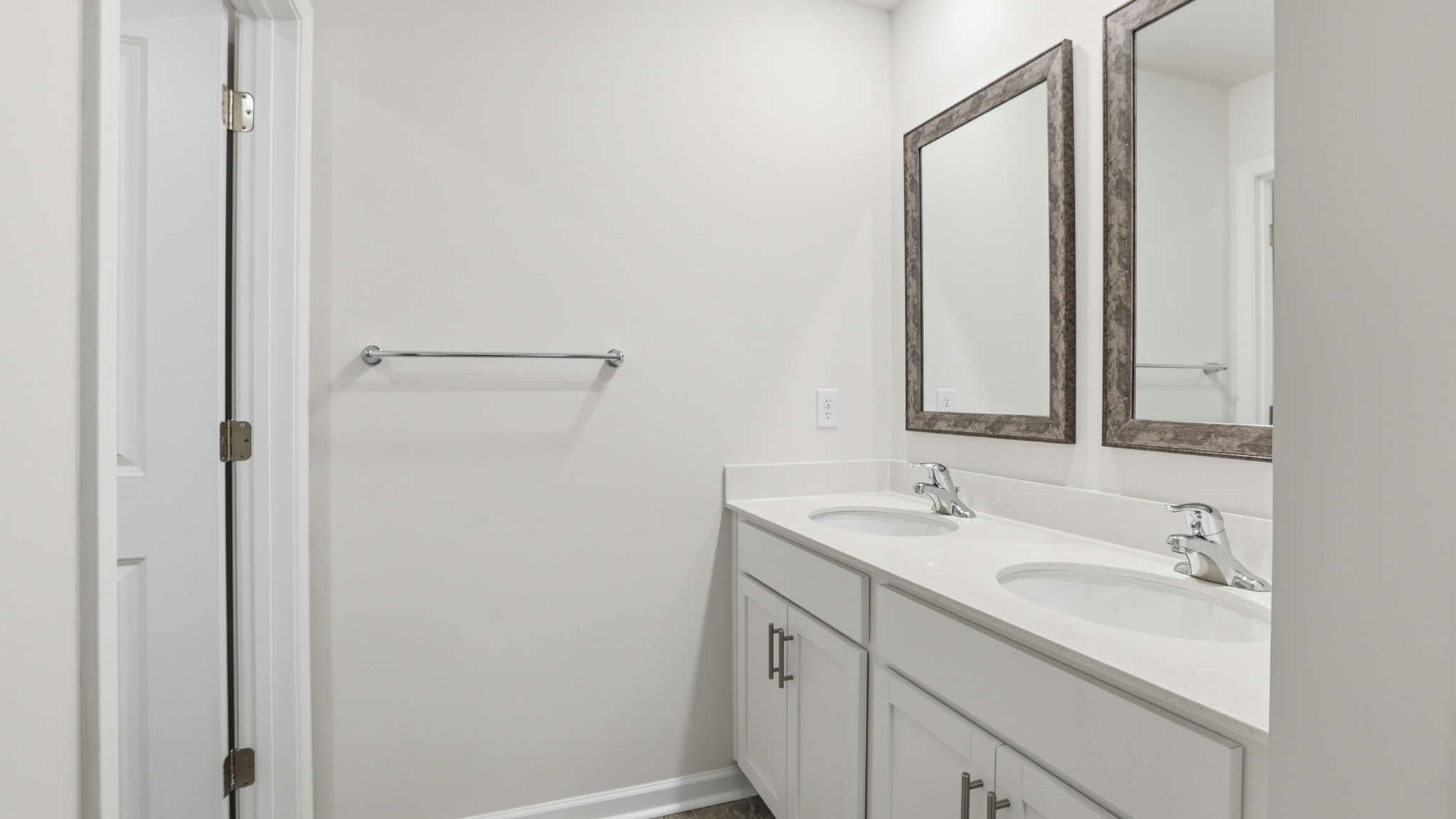 Hall bathroom with dual sink vanity separate from shower area.