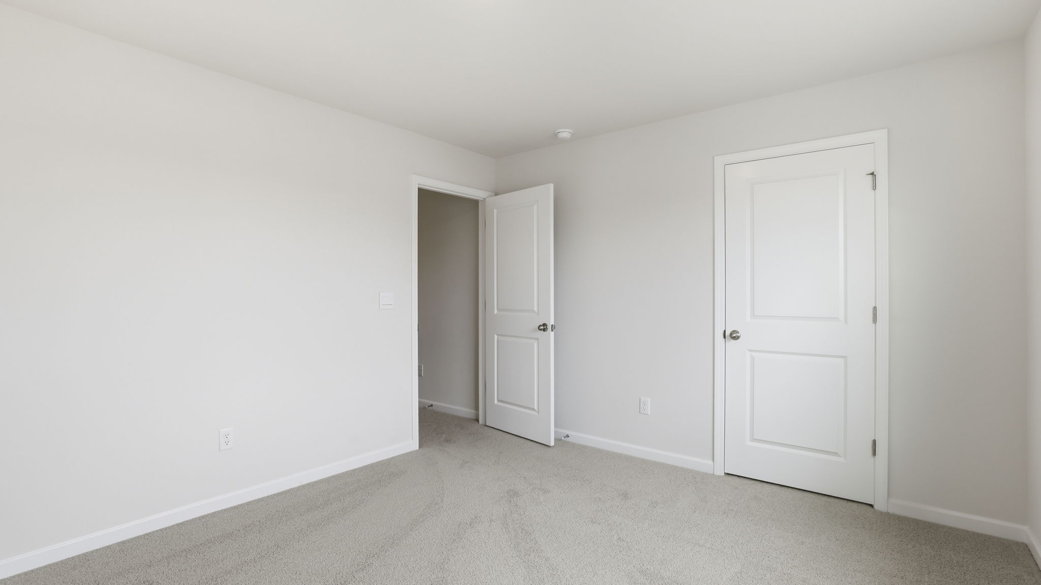 Bedroom with window and carpet.