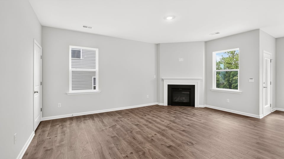 Family room with fireplace and window.