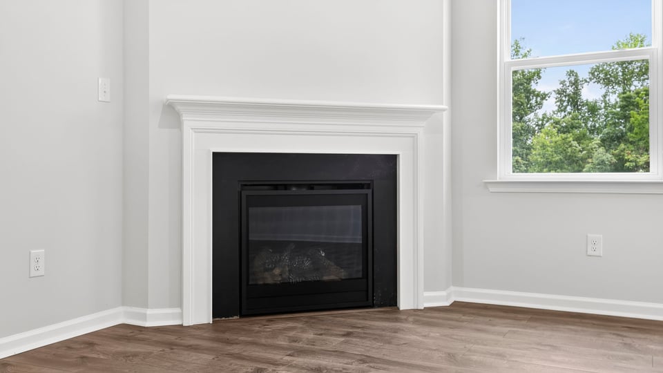 Family room with fireplace and window.